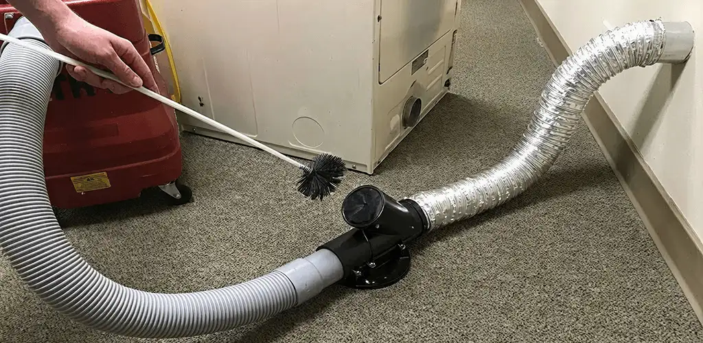 Dryer vent cleaning service removing lint from a dryer duct connection in Austin, TX
