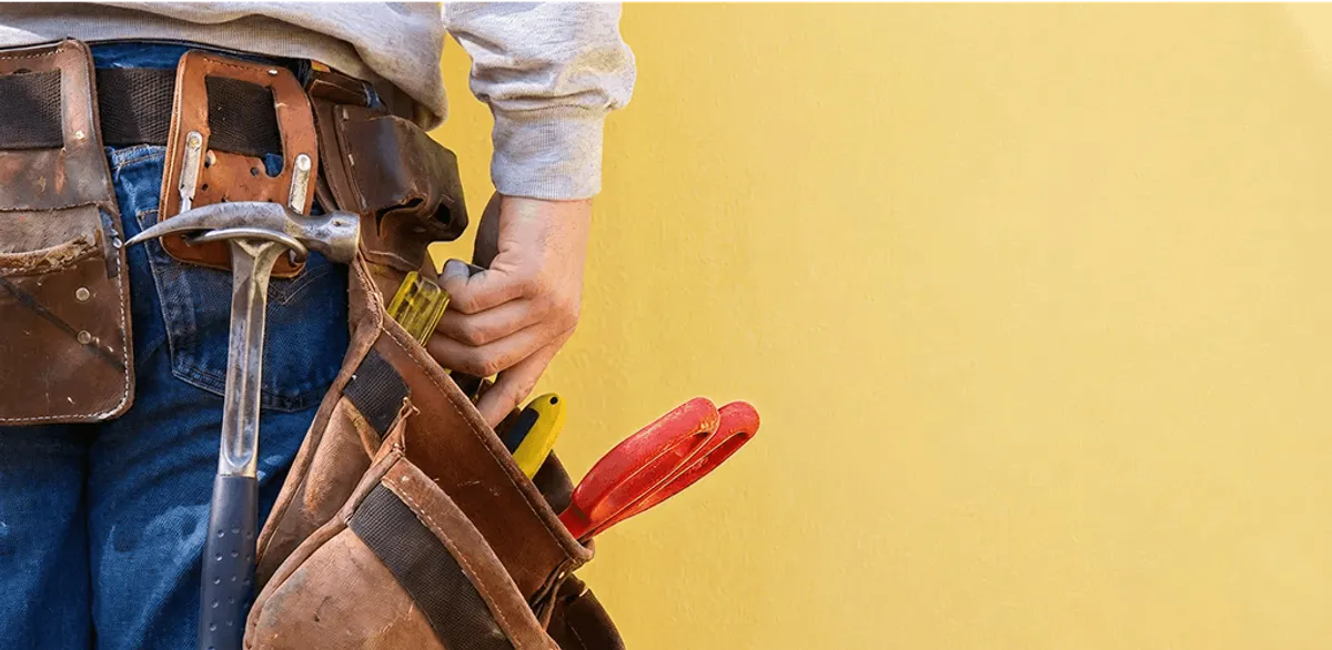 Handyman with tool belt ready for home repairs and maintenance in Austin, TX