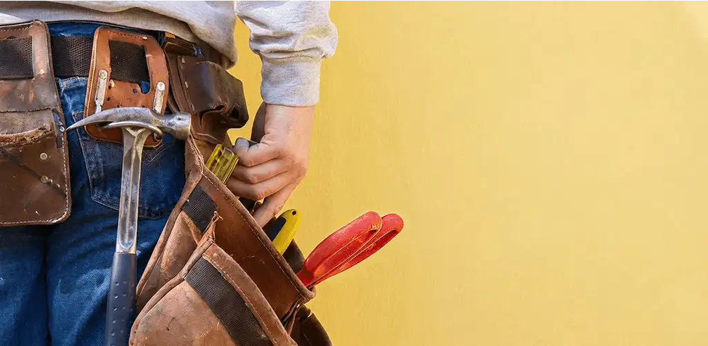 Handyman with tool belt ready for home repairs and maintenance in Austin, TX