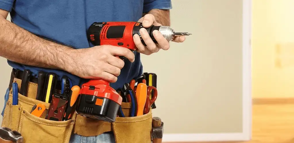 Handyman holding a power drill for home repairs and installations in Austin, TX