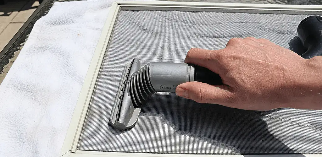 Window screen repair cleaning and fixing a damaged screen mesh in Austin, TX